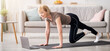 © Prostock-studio - Online sports during home isolation. Fit mature lady doing exercises in front of laptop indoors, copy space. Strong senior woman following video tutorial, working out on yoga mat, training her muscles