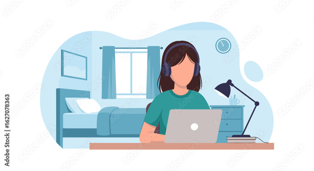 Young woman wearing headphones working on a laptop in her bedroom ...