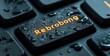 © btiger - Close-up of a black computer keyboard key with the word 'Rebrobong' illuminated in orange, covered in water droplets, conveying a sense of wetness and technology.