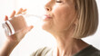 © Prostock-studio - Portrait of sporty mature woman drinking water during her workout indoors. Fit mature lady staying hydrated after domestic sports training. Healthy lifestyle concept