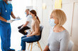 © Prostock-studio - Senior woman waiting for covid-19 vaccine injection, doctor checking patients' health before immunization at clinic. Coronavirus vaccination, protection against viral diseases campaign