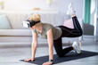 © Prostock-studio - Sports and virtual reality concept. Senior woman in VR headset exercising at home. Athletic mature lady using modern technologies for domestic workout, doing fitness indoors