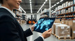 © G.K. Rezeki - Logistics professional using a tablet with digital data and analytics in a modern warehouse environment
