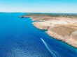 © Zedspider - Vrsi near Zadar archipelago cove beach in stone desert scenery near Zecevo island, Dalmatia in Croatia and Pag Island in background. Boat trip
