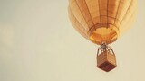 Hot air balloon ascending in serene daytime sky