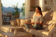 © Antonioguillem - Casual woman doing yoga on a sofa at home at sunset