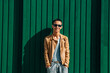 © tetxu - urban hispanic latin young man posing on green wall