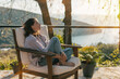 © olezzo - Young woman enjoying nature view from terrace