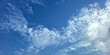 © Shuvro - Blue Sky with White Fluffy Clouds. Natural Background for Weather, Nature, and Travel Concepts. High resolution sky texture wallpaper. Clear sunny morning sky.