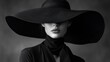 © Putro - Elegant woman in black with large hat in monochrome artistic portrait