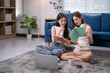 © Apichat - Two women sitting on the floor reading books