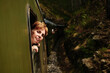 © Ekaterina - Woman looking out of a vintage train window in the mountains of Mokra Gora, enjoying the scenic ride. Sargan Eight - a popular tourist destination in Serbia.