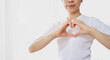 © Ton Photographer4289 - A young woman makes a heart shape with her hands to express her feelings of love and care.