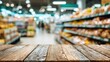 © rama - Wooden surface in front of blurred supermarket aisles.