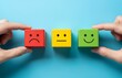 © shovons_gellary - Hands holding blocks with different facial expressions showing customer satisfaction levels