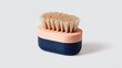 © zulfa - Oval-shaped brush with wooden handle and light beige bristles.  Dark navy blue base