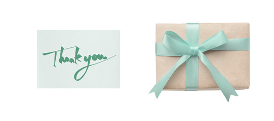 Wall Mural - overhead view of a green ribbon gift box next to a thank you card with green handwritten text