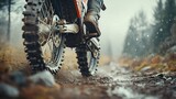 Muddy motocross bike on a wet trail