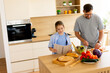 © BGStock72 - Cooking together in a modern kitchen with fresh ingredients and smiles