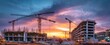 © Kovalenko - The vibrant construction site glowing under a stunning sunset backdrop.