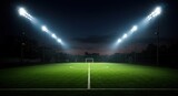 Illuminated soccer field at night, with goalposts visible in the distance.