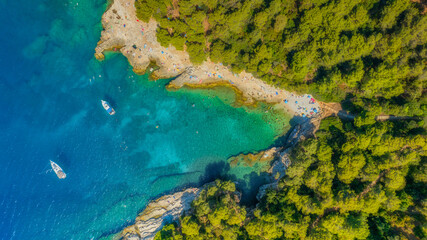 Wall Mural - aerial view on coast with rocks and forest. boat in the bay. vacation and relax at the summertime. b