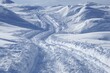 © BISO - bike tracks in pristine snow on sunny winter mountain