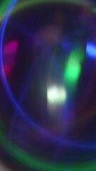 Wall Mural -  Shiny prism circles floating over a reflective pink and teal background with soft light waves. Abstract vertical background