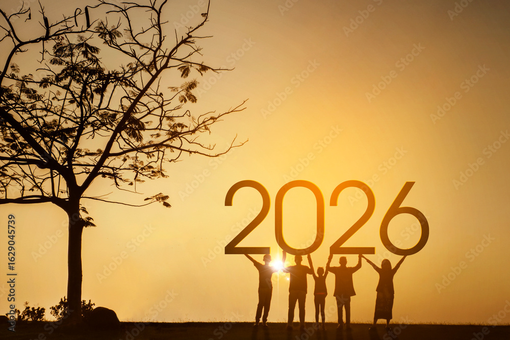 Silhouette of people holding up the year 2026 at a beautiful sunset ...