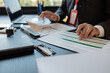 © PHOTO4U - a businessman reviews the company's financial documents in his office, the accountant is rushing to check the figures in the documents before submitting them to the tax office