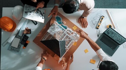Poster - Top down aerial view of smart architect engineer team inspect house model while manager hold blueprint and asking about building construction. Group of diverse engineer working together. Alimentation.