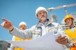 © Kristina - Engineer presents site plans to construction team under clear bright sky at a building project site