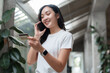 © Phimwilai - Young woman making online payment using credit card and smartphone