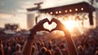 © Pixel Aria - Person forms heart hands at beach music festival with sunset light and crowd enjoying outdoor summer concert
