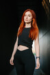 © dsheremeta - Confident woman with red hair in activewear outdoors