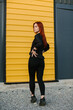 © dsheremeta - Woman exercising outdoors near colorful wall