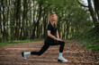 © dsheremeta - Woman stretching in forest during outdoor workout