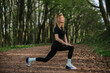 © dsheremeta - Woman stretching in forest for outdoor exercise