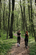 © dsheremeta - Women exercising on a forest trail in spring