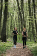 © dsheremeta - Women jogging on forest trail in spring