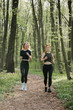 © dsheremeta - Women jogging through a serene forest trail