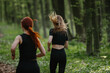 © dsheremeta - Two women running in the forest, enjoying exercise and nature