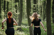 © dsheremeta - Women running through a forest trail