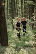 © dsheremeta - Women running through a forest trail