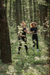 © dsheremeta - Energetic women running through forest trail
