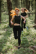 © dsheremeta - Two young women running in the forest, enjoying fitness and nature