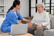 © Pixel-Shot - Physical therapist taking care of senior woman at home