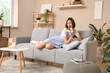© Pixel-Shot - Beautiful young shocked woman with tasty chocolate bar sitting on sofa at home