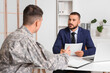 © Pixel-Shot - Male lawyer working with soldier in office
