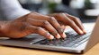 © PaulShlykov - Hands typing on a laptop keyboard in a modern workspace